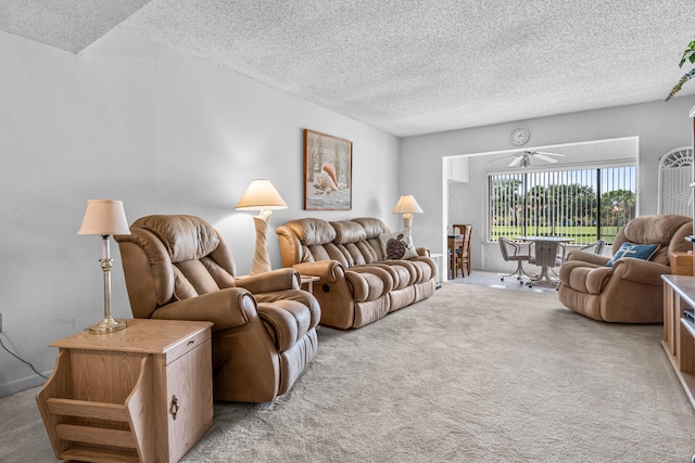 carpeted living room with ceiling fan and a textured ceiling