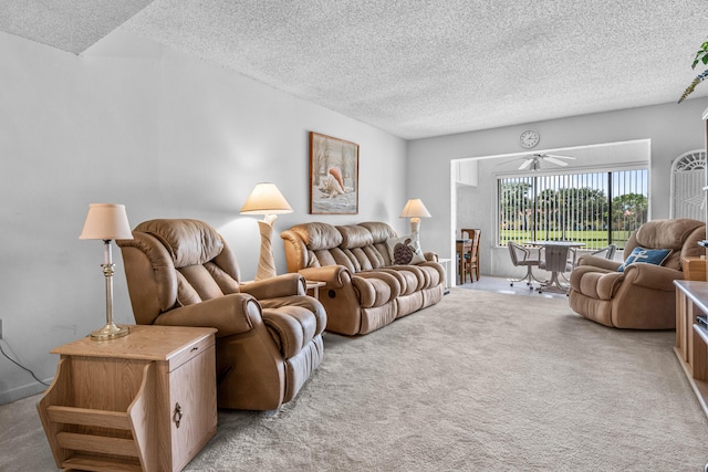living area with a textured ceiling, light carpet, and a ceiling fan