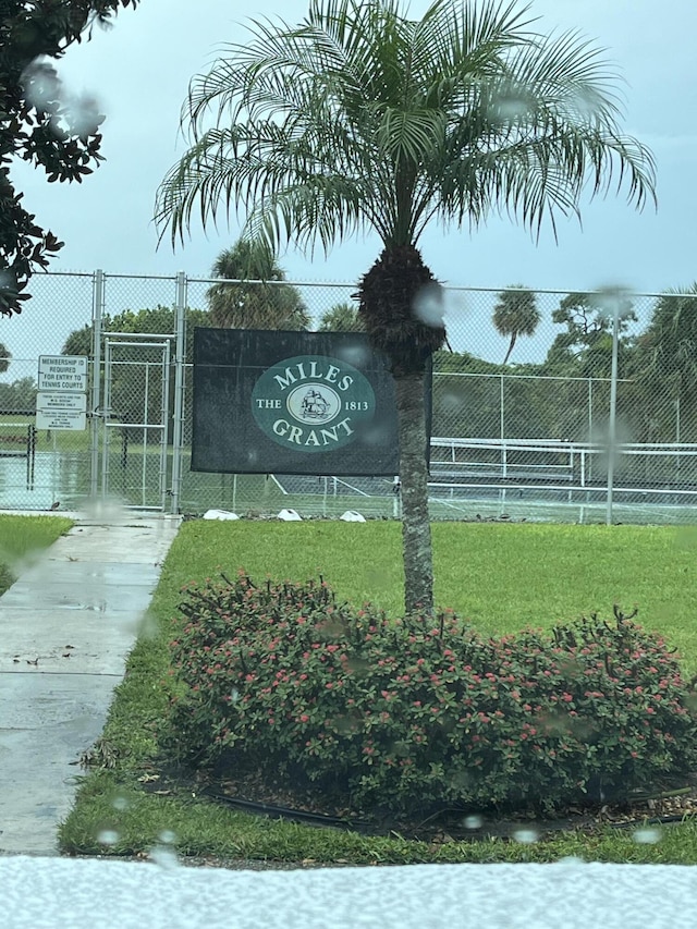 community sign featuring fence and a gate