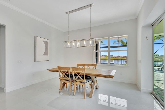 tiled dining area featuring ornamental molding and a water view