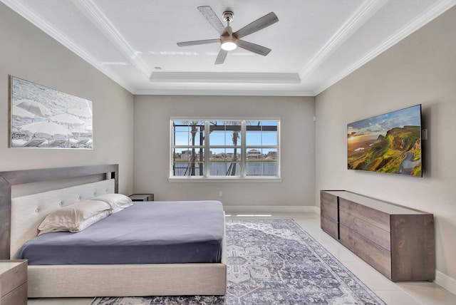 bedroom featuring light tile patterned flooring, ceiling fan, ornamental molding, and a tray ceiling