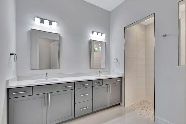 bathroom with vanity and tiled shower