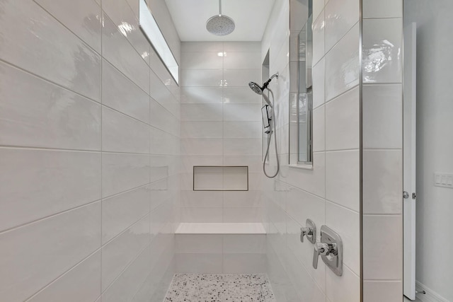 bathroom with a tile shower