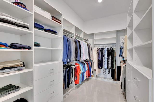 walk in closet with light tile patterned flooring