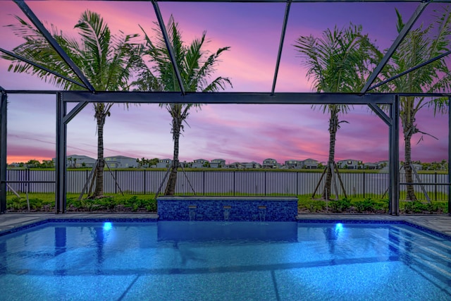 view of pool at dusk