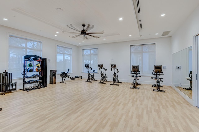 gym with ceiling fan and light wood-type flooring