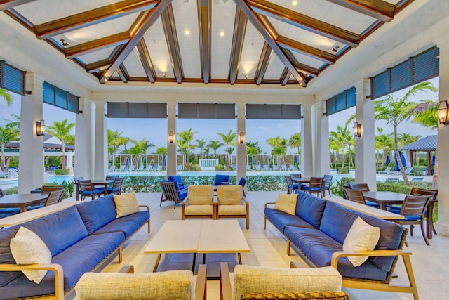 sunroom / solarium with lofted ceiling with beams