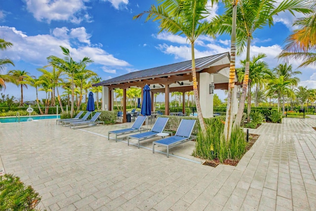 view of patio featuring a gazebo and a community pool