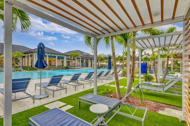 view of swimming pool featuring pool water feature, a pergola, a patio area, and a lawn