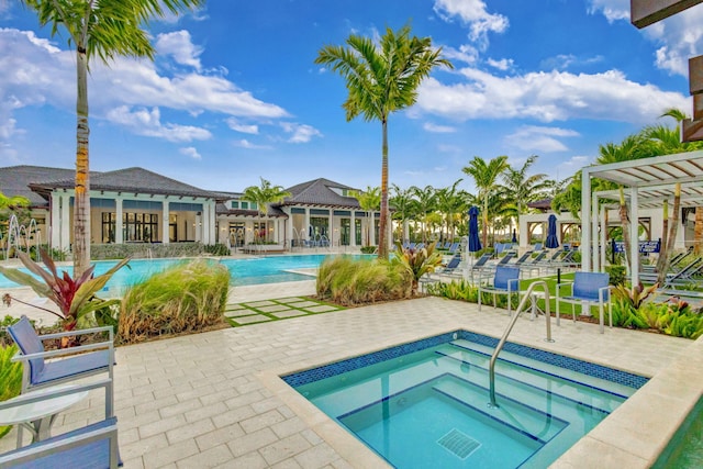 view of pool featuring a community hot tub, a pergola, and a patio