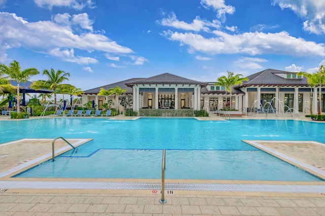 view of swimming pool with a patio and pool water feature