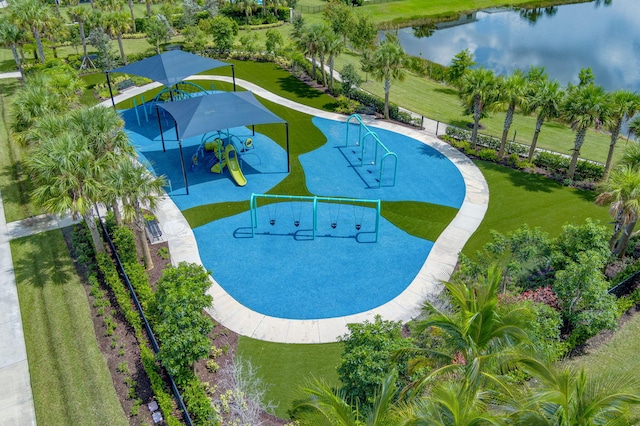 view of swimming pool with a playground, a water view, and a yard