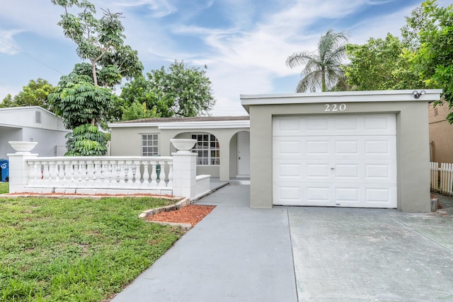 single story home featuring a garage and a front yard