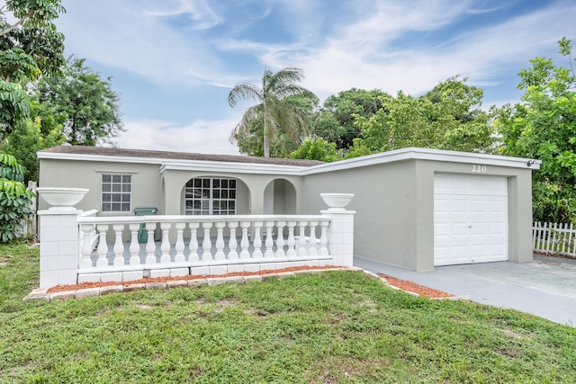 single story home featuring a garage and a front lawn