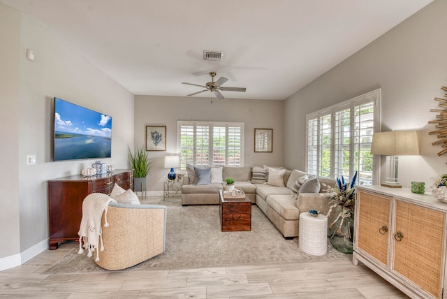 living room featuring plenty of natural light and ceiling fan