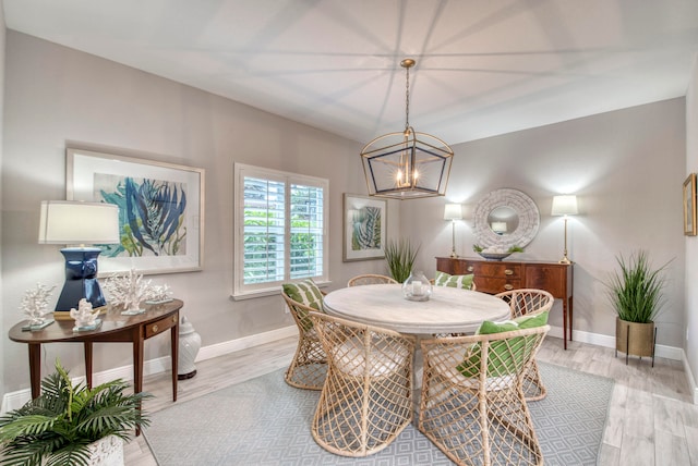 dining area with a chandelier and light hardwood / wood-style flooring