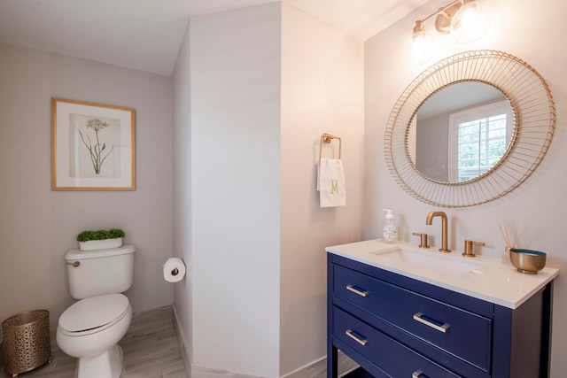 bathroom featuring hardwood / wood-style flooring, vanity, and toilet