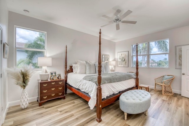 bedroom featuring multiple windows, light wood-type flooring, and ceiling fan