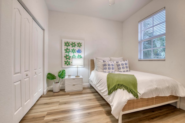 bedroom featuring light hardwood / wood-style flooring and a closet