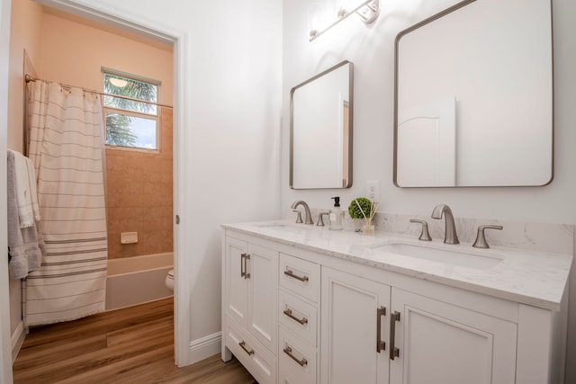 full bathroom with vanity, wood-type flooring, shower / tub combo, and toilet