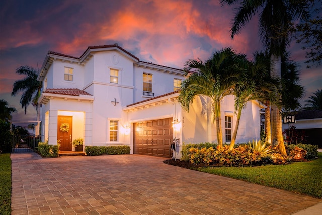 mediterranean / spanish-style house with a garage