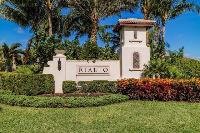 community sign featuring a lawn