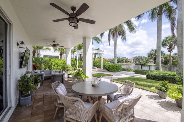 view of patio with a pergola, outdoor lounge area, ceiling fan, and a water view