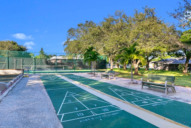 view of home's community with tennis court