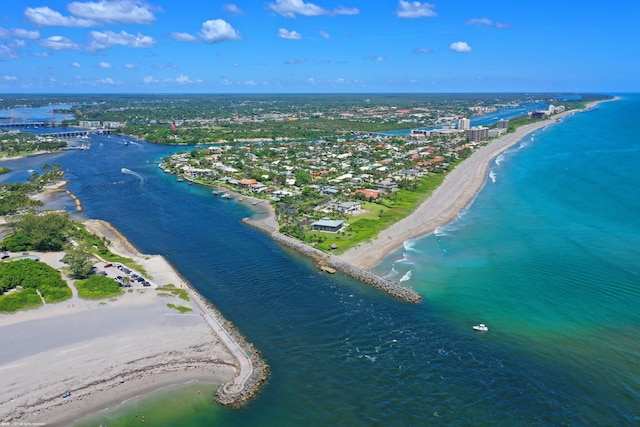 bird's eye view featuring a water view and a beach view