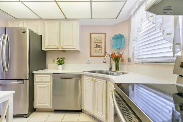 kitchen with sink, light tile patterned floors, and appliances with stainless steel finishes