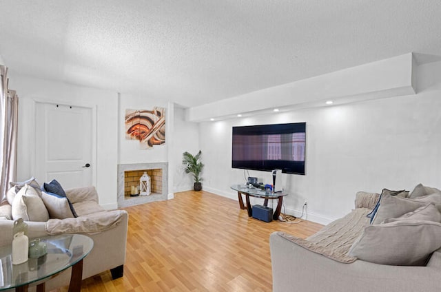 living room with a textured ceiling and hardwood / wood-style floors