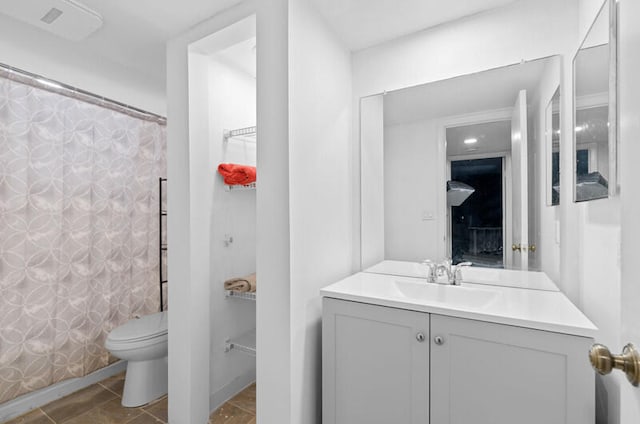 bathroom with vanity, toilet, and walk in shower