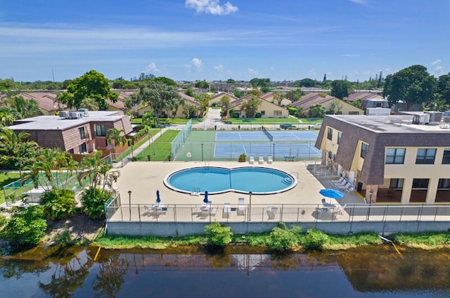 view of pool featuring a patio and a water view