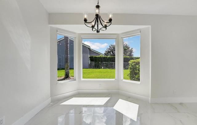 unfurnished dining area featuring an inviting chandelier