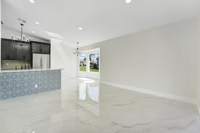 unfurnished living room with lofted ceiling and a chandelier