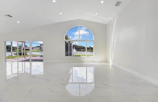 empty room with a wealth of natural light and vaulted ceiling