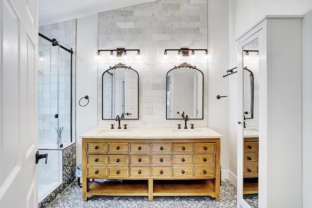 bathroom featuring tile patterned flooring, vanity, a shower with shower door, and vaulted ceiling