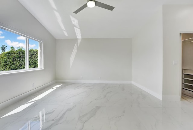 interior space featuring lofted ceiling and ceiling fan