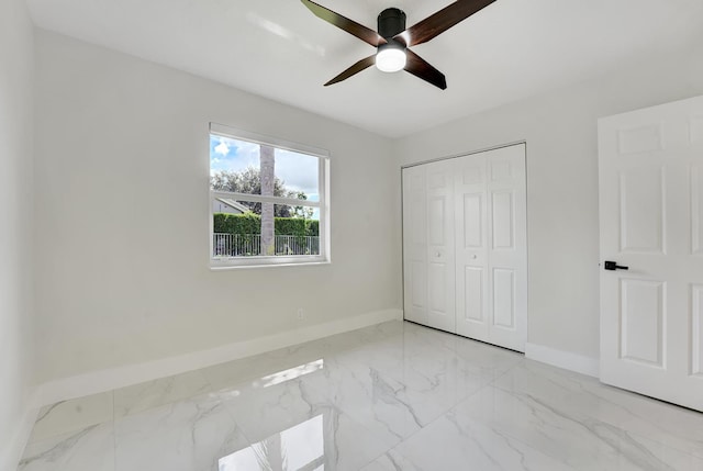 unfurnished bedroom with ceiling fan and a closet