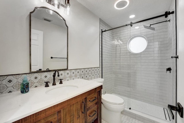 bathroom featuring an enclosed shower, toilet, and vanity