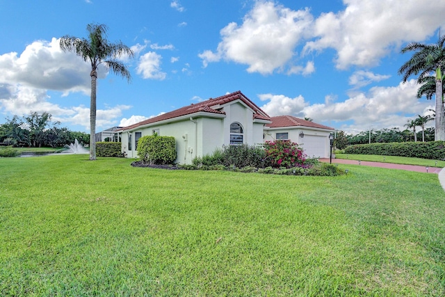 view of side of property with a yard and a garage