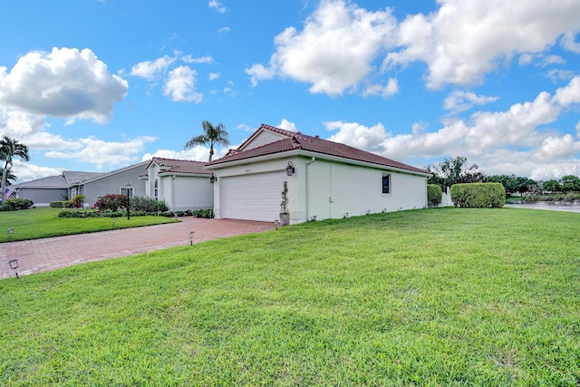 exterior space with a garage and a front lawn