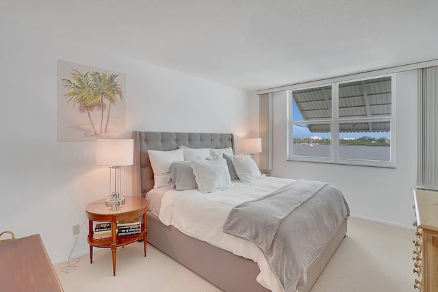 bedroom featuring light colored carpet