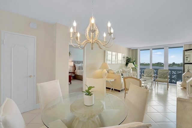 dining space featuring floor to ceiling windows, a notable chandelier, and light tile patterned flooring