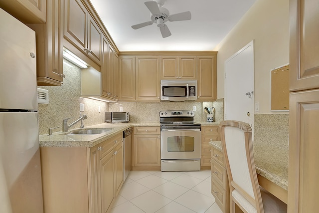 kitchen featuring light tile patterned floors, ceiling fan, light brown cabinets, and stainless steel appliances