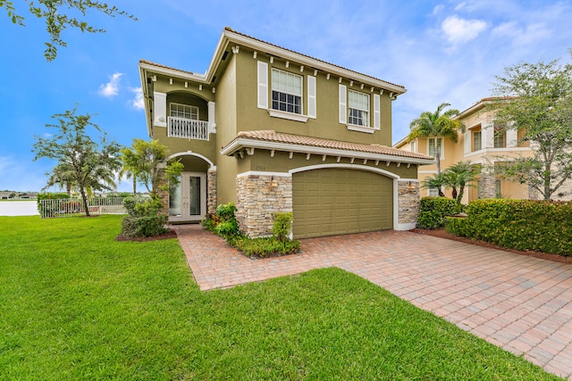 mediterranean / spanish-style home featuring a garage and a front lawn