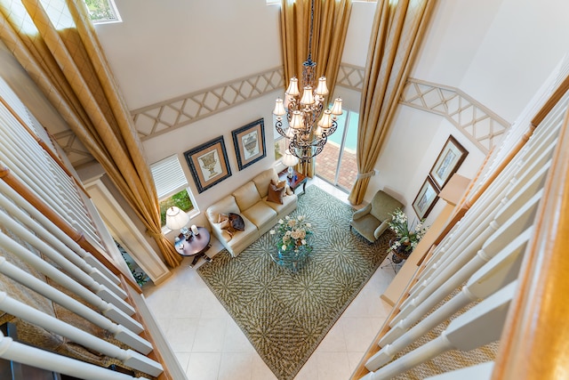 living room featuring a towering ceiling, a wealth of natural light, and light tile patterned flooring