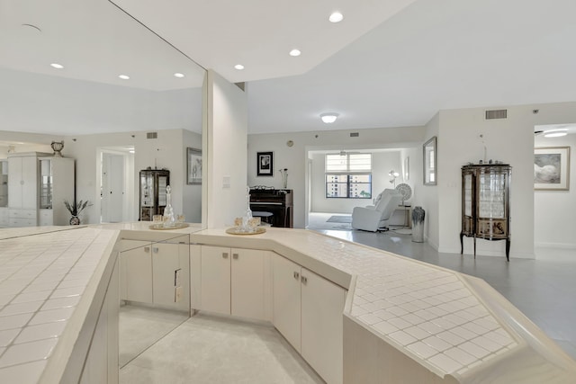 7567 Imperial Dr Unit 601, Boca Raton, FL 33433 - kitchen with tile counters, open floor plan, recessed lighting, and a peninsula