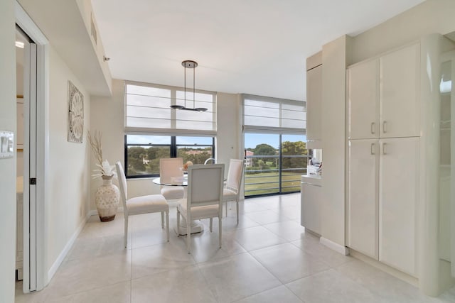 dining area featuring light tile patterned flooring