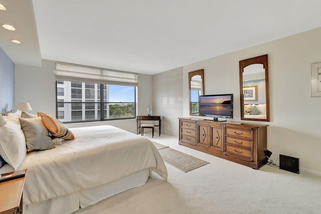 bedroom featuring light colored carpet